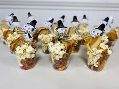 small cups filled with candy and marshmallows decorated as witches for halloween treats