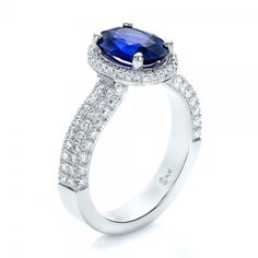 Custom Blue Sapphire and Diamond Halo Engagement Ring Oval Sapphire Ring With Pave Setting In Platinum, Classic Sapphire Ring With Pave Setting, Luxury Blue Diamond Ring With Pave Setting, Luxury Oval Sapphire Ring With Pave Setting, Classic Sapphire Rings With Pave Setting, Blue Diamond Ring With Pave Setting In Platinum, Classic Blue Rings With Pave Setting, Blue Oval Diamond Ring With Polished Finish, Oval Blue Diamond Ring With Pave Setting