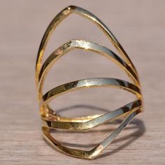 The School Lane: Yellow Gold Cocktail Statement Ring. The Ring Features Five Rows Of Polished Gold In A Chevron Shape To Straight In A Pattern To Create A Large Fan Across The Top Of The Finger. The Ring Is Crafted In Yellow Gold And Is Currently A Finger Size 6.25 Yet Can Be Adjusted To Any Finger Size For An Additional Charge On Request. White Gold Rings With Unique Design For Formal Occasions, Formal White Gold Rings With Unique Design, Gold Fusion Style Ring Jewelry, Formal 14k Gold Jewelry With Unique Design, 14k Gold Jewelry With Unique Design For Formal Occasions, Wedding Rings With Plating In Fine Jewelry Style, Wedding Rings With Plating Fine Jewelry, Wedding Fine Jewelry Rings With Plating, Fusion Style Yellow Gold Open Ring Jewelry