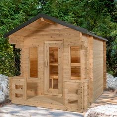 a small wooden sauna in the middle of some rocks