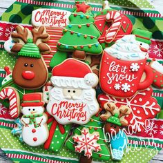 decorated christmas cookies in the shape of santa claus and other holiday treats on a platter