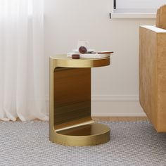 a gold side table with a plate on it