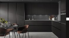 a modern kitchen with black cabinets and brown chairs