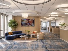 an office lobby with couches, tables and chairs