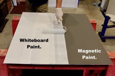 a man is painting the side of a table with whiteboard paint and magnetic paint