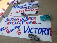 several signs and shoes are laid out on the ground with words written in red, white and blue