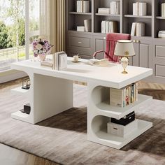 a white desk with bookshelves in front of it and a lamp next to it