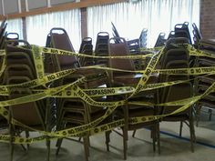 there are many chairs with caution tape around them