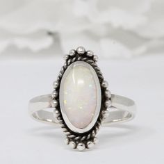 ☉ Metal Type: Sterling Silver. ☉ Metal Stamp or Hallmark: .925 ☉ Metal Purity: 92.5% Sterling. ☉ Finish: Oxidized ☉ Stone: White Lab Opal ☉ Face Measurements From South To North: 11.4mm Custom orders welcome! Classic Opal Oval Cabochon Ring For Promise, Classic Opal Oval Cabochon Promise Ring, Classic Oval Cabochon Opal Promise Ring, Classic Opal Promise Ring With Oval Cabochon, Oval Opal Promise Ring, Classic Oval Opal Ring, Vintage Silver Opal Ring With Oval Shape, Vintage Silver Oval Opal Ring, Classic Oval Cabochon Opal Ring