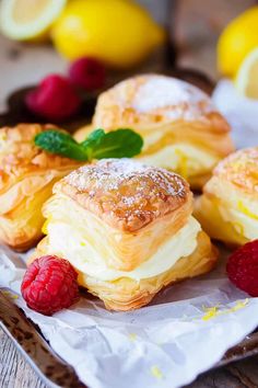 pastries with raspberries and lemons on a plate