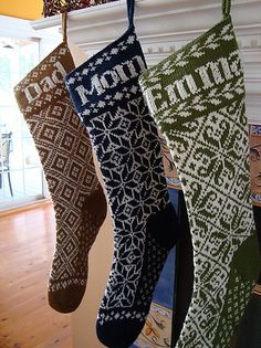 three christmas stockings hanging from a fireplace