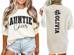 Show your spirit on game day with our custom Cheerleader Aunt shirt, featuring a varsity style "cheer auntie" design personalized with the cheerleaders name on back. This cute and stylish shirt makes the perfect gift for any cheer auntie passionate about cheerleading. COMFORT COLORS 1717 SHIRT: Unisex 100% US cotton - ethically grown and harvested Pre-Shrunk Fabric Relaxed Fit - Size up for a trendy oversized look Seamless Sides Double Needle Stitching Garment-dyed  CARE INSTRUCTIONS: Wash insid Customizable Casual T-shirt For Cheerleading, Cheer Aunt Shirt Ideas, Varsity T-shirt With Custom Print For Game Day, Customizable White Collegiate Tops, School Spirit Tops With Custom Print For Fan Gear, Custom Print School Spirit Tops For Fan Gear, School Spirit Fan Gear Tops With Custom Print, Custom Print Tops For School Spirit Fan Gear, Varsity Crew Neck Tops For Cheerleading