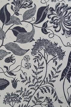 an intricately designed wallpaper with blue flowers and leaves