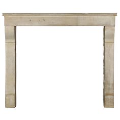 a white marble fireplace mantel with an arched top and two columns on each side