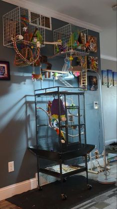 a bird cage sitting in the corner of a room