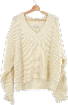 Oversized Cream V-neck Sweater, Oversized Chunky Knit V-neck Sweater For Fall, Casual Winter White V-neck Sweater, Trendy Oversized White V-neck Sweater, Cozy Oversized Knitted V-neck Sweater, Winter White V-neck Sweater For Fall, Winter Cable Knit V-neck Cropped Sweater, Winter White V-neck Sweater, Trendy Winter White V-neck Sweater