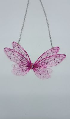 Discover the new magnificent collection of resin fairy wing necklaces. They have been created with love to add a magical and magical touch to your day! *The fairy wing necklace was created by me in my magical workshop. The necklace has a stainless steel chain adjustable by an extension chain. These high-end jewelry pieces are both elegant and durable. *The magical and magical fairy wings are made from resin which is a delicate but sturdy material once hardens. A certain light and shine has been Fairy Wing Necklace, Pink Butterfly Necklace For Party, Handmade Fairy Grunge Necklaces For Party, Handmade Pink Fairy Jewelry, Fairy Grunge Handmade Party Necklaces, Fairy Grunge Handmade Necklace For Party, Fairy Grunge Handmade Party Necklace, Fairycore Butterfly Necklace Gift, Handmade Butterfly Necklace For Parties