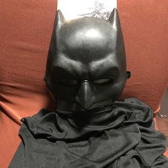 a batman mask sitting on top of a couch