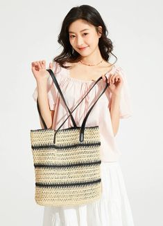 Make a statement with our Woven Striped Tote with Leather Handles, perfect for an effortlessly stylish look. With its durable cellulose material and trendy color-blocking design, this tote boasts a chic vertical square shape and features a practical internal phone pocket. The soft texture and striped pattern add a touch of sophistication, while the leather handles ensure comfortable carrying, making it an ideal accessory for your daily endeavors or leisure activities. Take this versatile tote to Versatile Rectangular Straw Bag For Daily Use, Chic Large Capacity Straw Bag For Shopping, Spring Rectangular Bucket Bag For Daily Use, Trendy Rectangular Bucket Bag For Shopping, Square Bucket Bag With Braided Handles, Summer Black Bucket Bag For Shopping, Rectangular Summer Shoulder Bag For Shopping, Chic Large Capacity Rectangular Beach Bag, Summer Style Rectangular Shopping Shoulder Bag