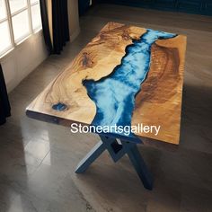 a table with a river running through it in the middle of a room next to a window