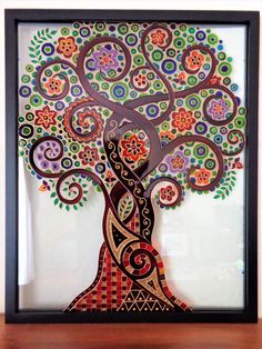 a colorful tree with swirls and leaves on it's sides is in a black frame