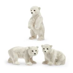 three white polar bears standing next to each other