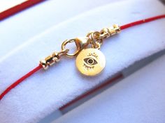 FOR GOOD LUCK AND PROTECTION the traditional Kabbalah red string bracelet with gold evil eye with onyx all parts are gold filled Jewelry can be wear by both man and women. Red string in the Kabbalah, bring luck and protection to the one who wear it. Item: SY 8geo Thanks for visitng symbolina store - http://www.etsy.com/shop/Symbolinajewelry Have a lucky day Jewelry comes in a classic elegant box We recommend not swimming, showering or sleeping in your jewelers, avoid spraying your jewelers with Handmade Yellow Gold Evil Eye Bracelet Gift, Gold Adjustable Evil Eye Bracelet For Good Luck, Red String Bracelet, Protection Amulet, Red String, For Good Luck, Blue Evil Eye, Star Bracelet, Minimalist Bracelet