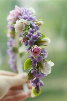 a person is holding flowers in their hand