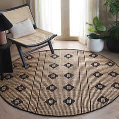 a chair sitting on top of a wooden floor next to a large rug in front of a window