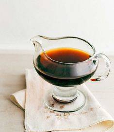 a glass pitcher filled with liquid sitting on top of a napkin