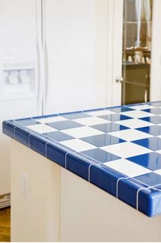 a blue and white checkered counter top in a kitchen