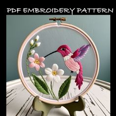 the embroidery pattern shows a hummingbird and flowers