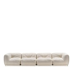 a white couch sitting on top of a white floor