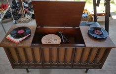 an old record player with vinyl records in it