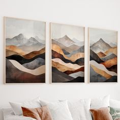 three paintings hanging on the wall above a couch