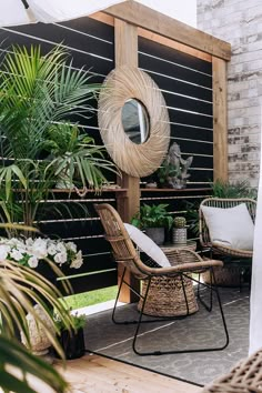 an outdoor patio with plants and wicker furniture