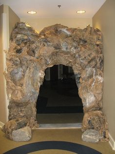 a large rock arch in the middle of a hallway