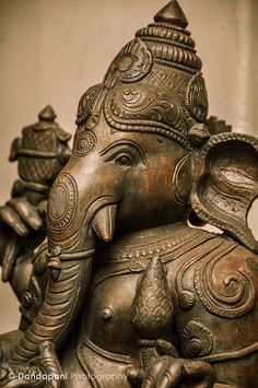 an elephant statue sitting on top of a wooden table