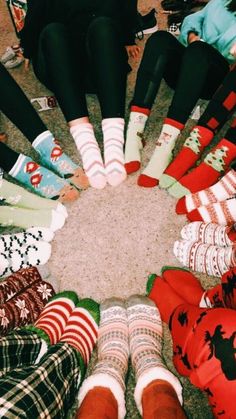 a group of people standing in a circle wearing socks