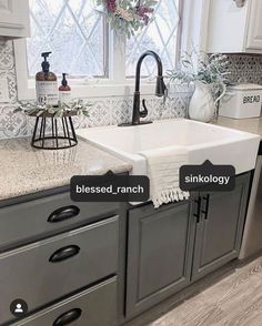 a kitchen sink sitting under a window next to a dishwasher and a counter top