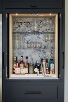 a cabinet filled with liquor bottles and glasses