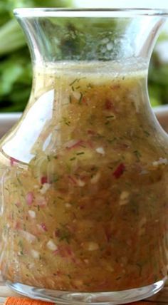 a glass jar filled with food sitting on top of a table next to a bowl