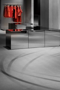 an empty room with mirrored cabinets and clothes