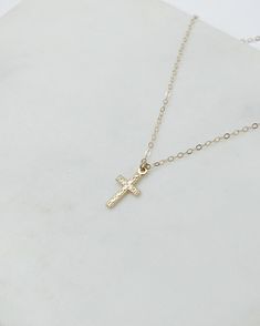 gold cross necklace, dainty cross necklace, gold necklace, cross necklace, dainty jewelry, gifts for her, religious necklace, gifts for women Dainty textured cross pendant necklace The prefect staple piece made to last! D E T A I L S: *Gold filled or sterling silver textured cross pendant 8x15mm *Dainty Gold filled or sterling silver cable chain- choose your perfect length at checkout SHIPPING: *Free domestic shipping on all orders over $35. PACKAGING: *All pieces come beautifully packaged, perf Gold Crucifix Cross Necklace With Delicate Chain, Gold Cross Charm Necklaces In 14k Gold Filled, 14k Gold Filled Cross Pendant Necklace, 14k Gold-filled Gold Cross Pendant Necklace, Gold Cross Pendant Necklace In 14k Gold Filled, 14k Gold Filled Gold Cross Necklace, Gold Crucifix Charm Necklace In Minimalist Style, Gold Minimalist Crucifix Charm Necklace, Minimalist Gold Crucifix Charm Necklace