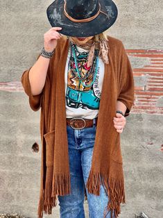 A beautiful rust poncho to brighten up any outfit Dolman sleeve style One size fits all Shown with the Ella Tee by Texas True Threads Also pairs great with our Callie's Boot Scootin' Boogie Tee Rust And Turquoise Outfit, Oversized Fringe Casual Poncho, Oversized Fringe Poncho Casual Style, One Size Festival Tops For Fall, Oversized Bohemian Sweater For Fall, One Size Fringe Sweater For Fall, Knit Fringe Outerwear For Fall, Fringe Shawl Cardigan For Fall, Knit Outerwear With Fringe For Fall