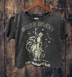 Urban Cowboy black acid wash regular baby doll Cropped T-shirt Measurements Small -18 inches wide- 16 inches from neck line to bottom Medium- 19 inches wide- 17 inches from neck line to bottom Large-21 inches wide - 18 inches from neck line to bottom   4.0 oz., 50/50 combed ringspun cotton/polyester Solids:  White are Vintage Jersey So soft Acid Wash Set-in ribbed neckband Double-needle stitching at sleeve & bottom hem Tearaway label Black Grunge Cropped T-shirt With Letter Print, Distressed Cotton Crop Top, Vintage Crop Top With Graphic Print, Vintage Cropped Crop Top With Graphic Print, Black Graphic Print Grunge Crop Top, Black Stonewashed Grunge Tops, Black Grunge Graphic Print Crop Top, Black Stonewashed Grunge Top, Black Grunge Crop Top With Graphic Print