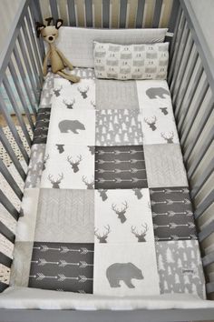 a baby crib with a stuffed animal on it's side and the words, white arrows, stag, bear, rustic