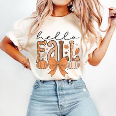 a woman wearing a t - shirt that says hello fall with pumpkins on it