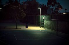 an empty basketball court at night with the lights on and no one in it yet