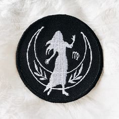 a black and white patch with an image of a woman on it